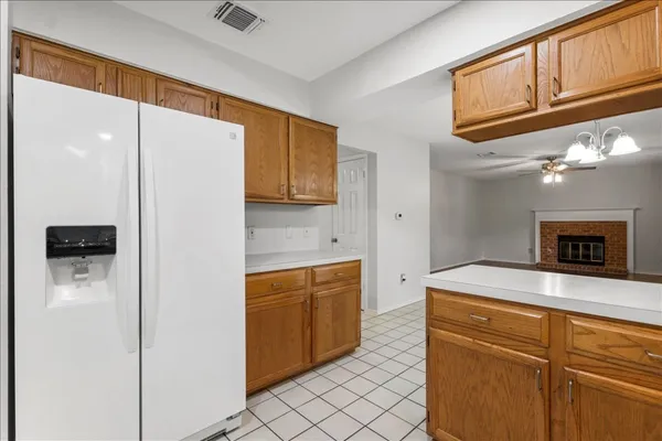 a kitchen with stainless steel appliances granite countertop a refrigerator and a stove top oven