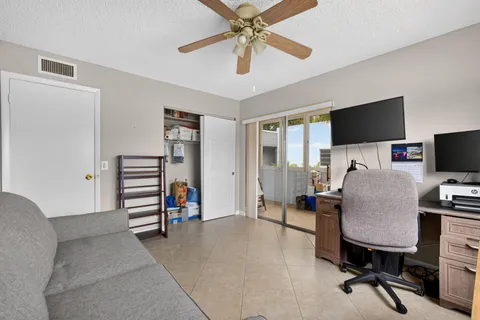 a view of a livingroom with workspace and a window