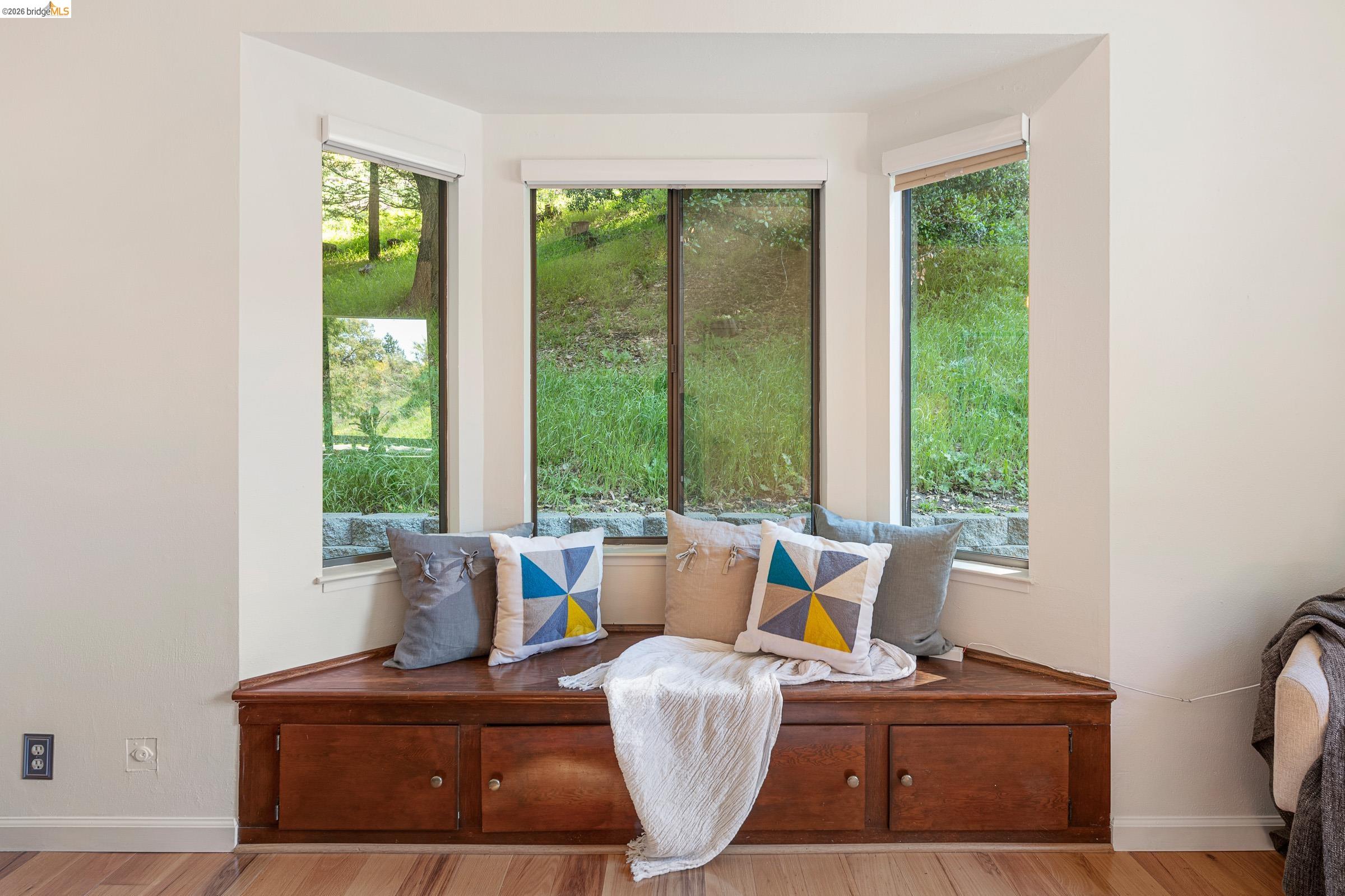 6600 Heather Ridge Way Oakland, CA 94611 - Photo 40 of 66 Bay window with a built-in wood-finish window seat featuring cabinet storage