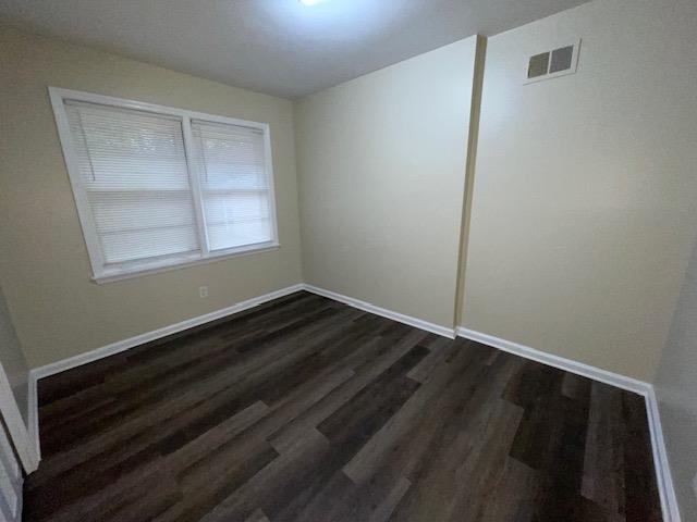 3284 Parham Street Memphis, TN 38127 - Photo 14 of 17 an empty room with wooden floor and windows