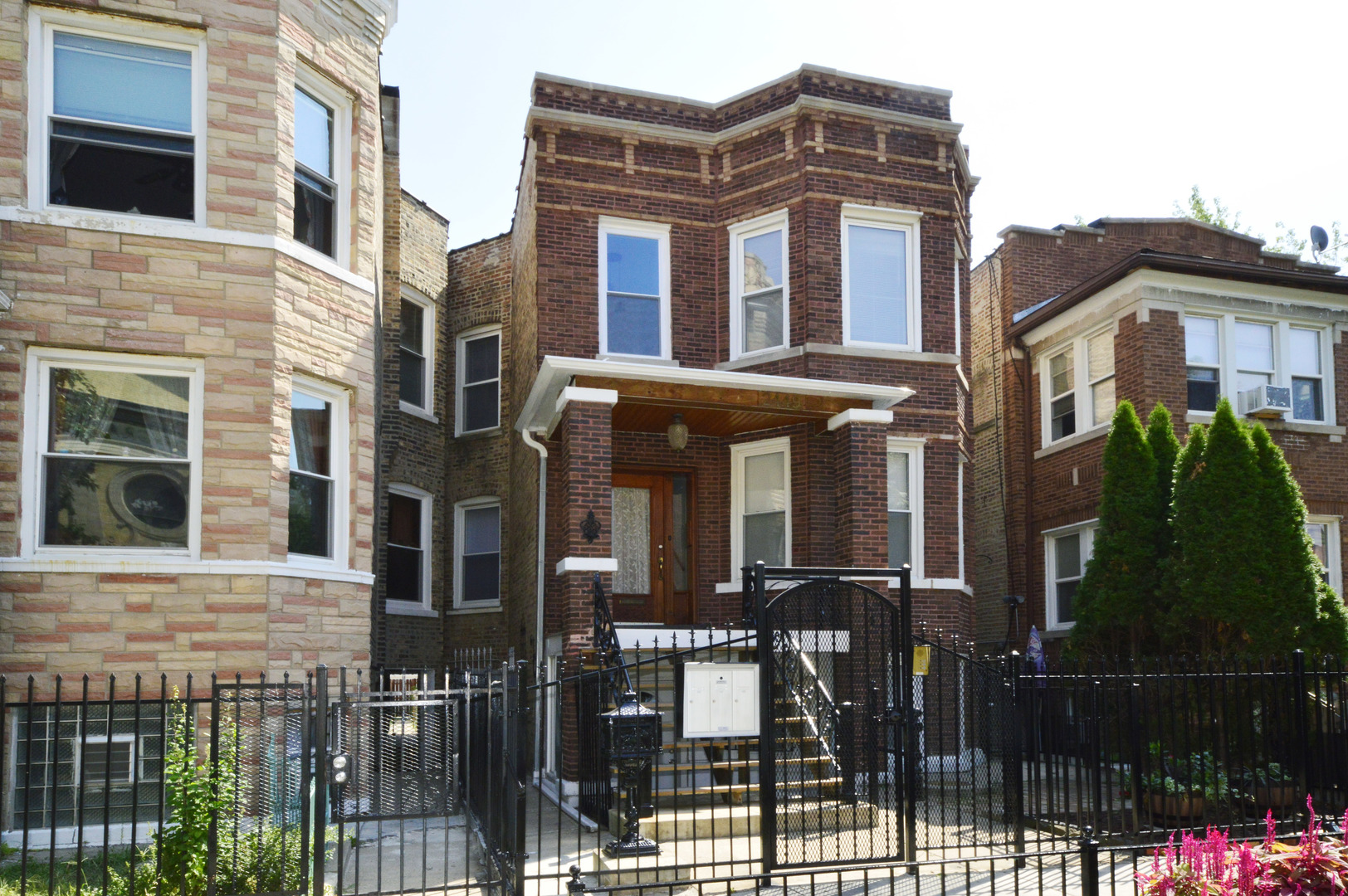 2449 North Ridgeway Avenue, Unit G Chicago, IL 60647 - Photo 1 of 7 a front view of a residential apartment building with a yard