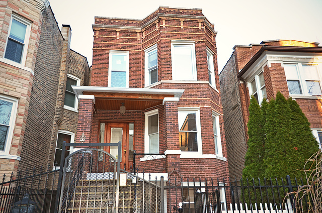 2449 North Ridgeway Avenue, Unit G Chicago, IL 60647 - Photo 2 of 7 a front view of a residential apartment building with a yard