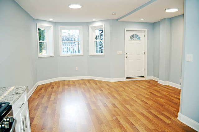 2449 North Ridgeway Avenue, Unit G Chicago, IL 60647 - Photo 3 of 7 a view of empty room with wooden floor and fan