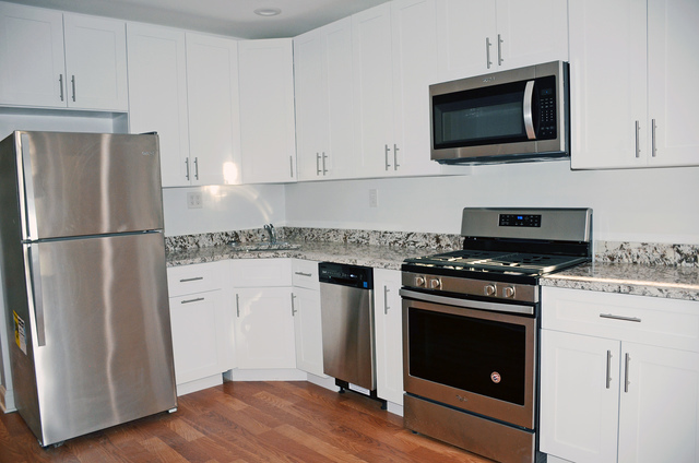 2449 North Ridgeway Avenue, Unit G Chicago, IL 60647 - Photo 4 of 7 a kitchen with stainless steel appliances a stove a microwave and a refrigerator