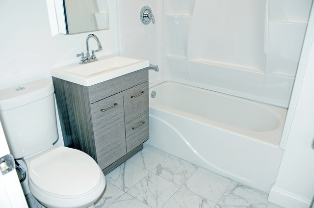 2449 North Ridgeway Avenue, Unit G Chicago, IL 60647 - Photo 5 of 7 a bathroom with a sink a toilet and shower