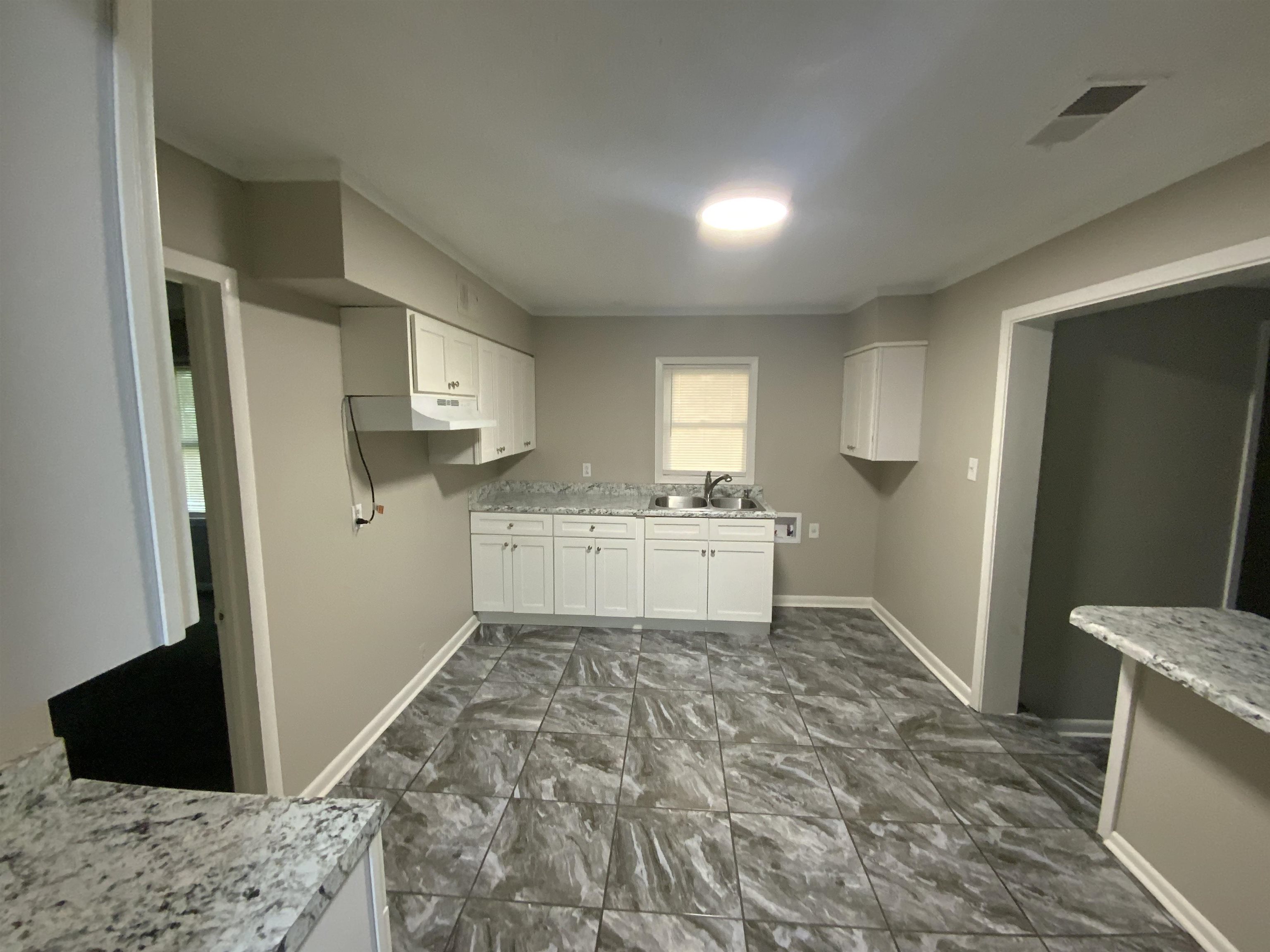 3560 Steele Street Memphis, TN 38127 - Photo 11 of 19 a view of a kitchen with refrigerator sink and wooden floor