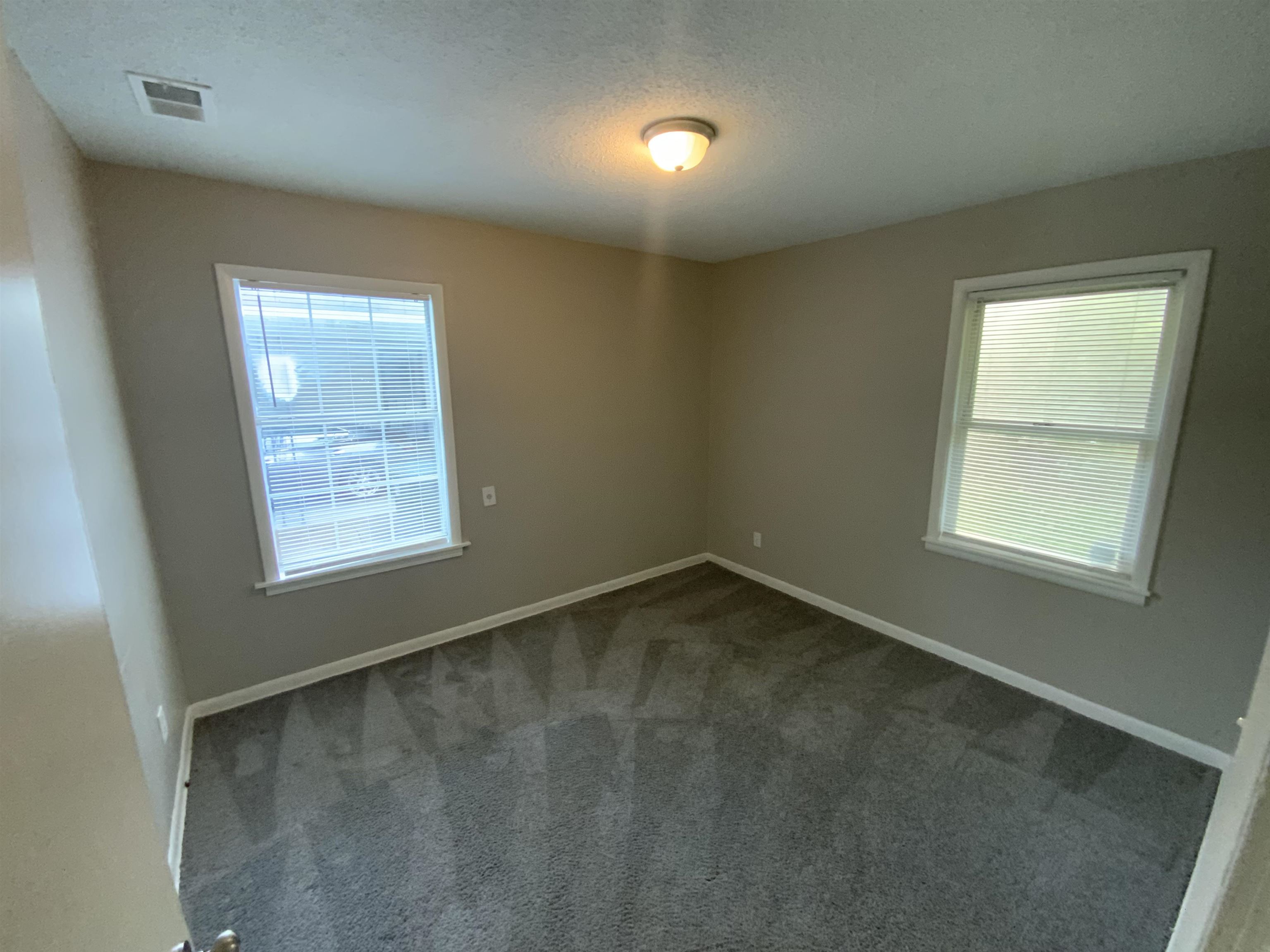 3560 Steele Street Memphis, TN 38127 - Photo 16 of 19 Unfurnished room with carpet flooring, plenty of natural light, and a textured ceiling