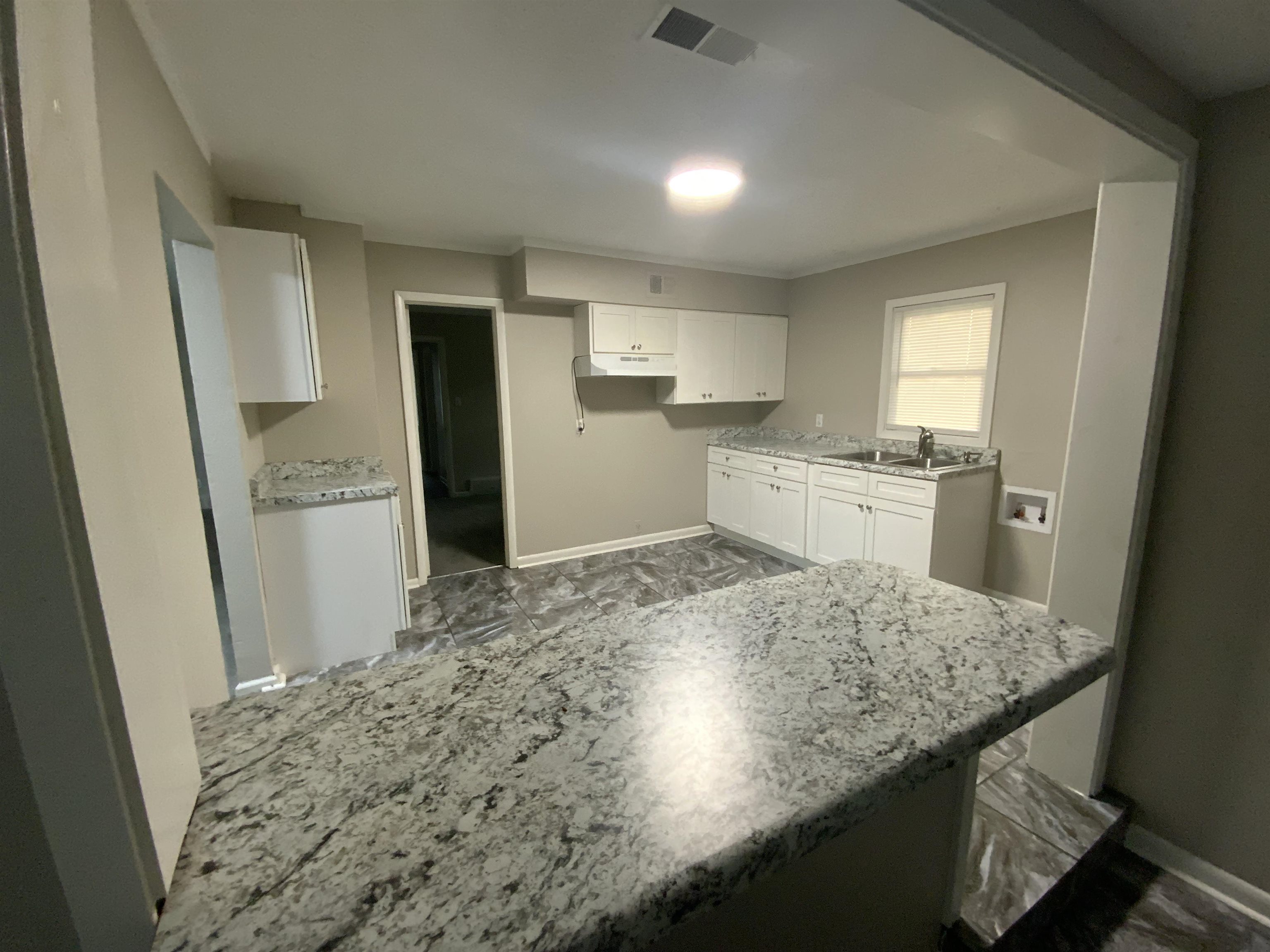 3560 Steele Street Memphis, TN 38127 - Photo 10 of 19 Kitchen featuring white cabinetry and light stone countertops