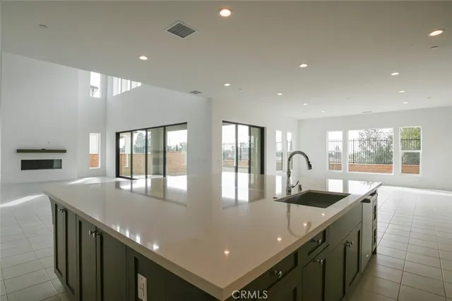 a kitchen with stainless steel appliances a sink stove and cabinets
