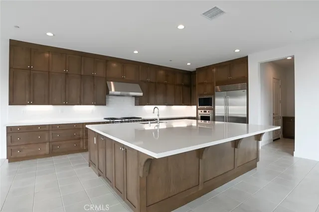 a kitchen with granite countertop a cabinets and stainless steel appliances