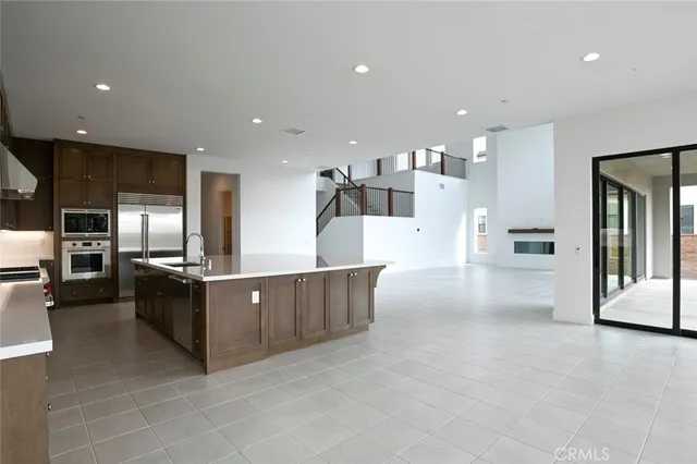 a kitchen with granite countertop a sink and white cabinets
