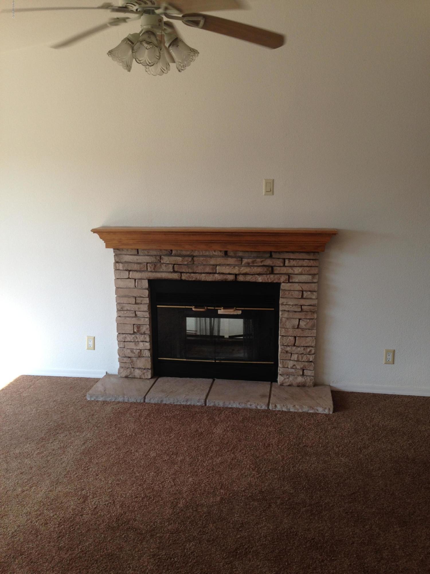 15146 North Ironwood Tree Road Tucson, AZ 85739 - Photo 6 of 9 a living room with a fireplace