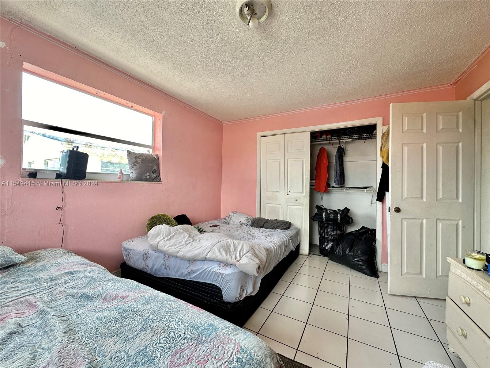 855 West 29th Street, Unit 14 Hialeah, FL 33012 - Photo 11 of 16 a bedroom with two beds and a dresser