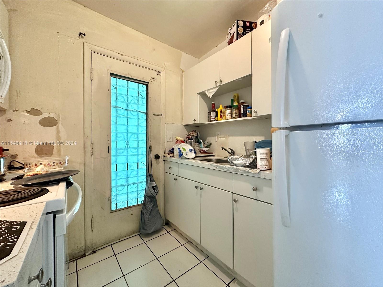 855 West 29th Street, Unit 14 Hialeah, FL 33012 - Photo 14 of 16 a kitchen with a refrigerator and a sink