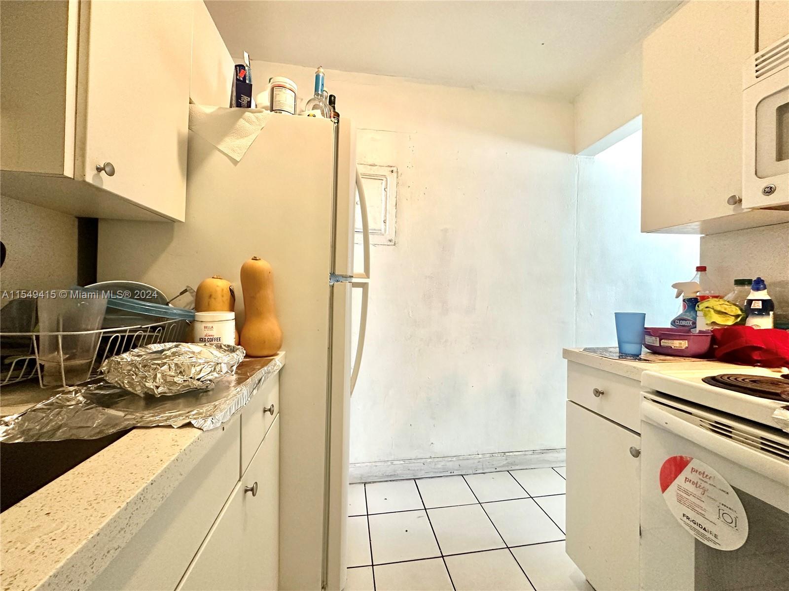 855 West 29th Street, Unit 14 Hialeah, FL 33012 - Photo 15 of 16 a kitchen with a refrigerator and a stove