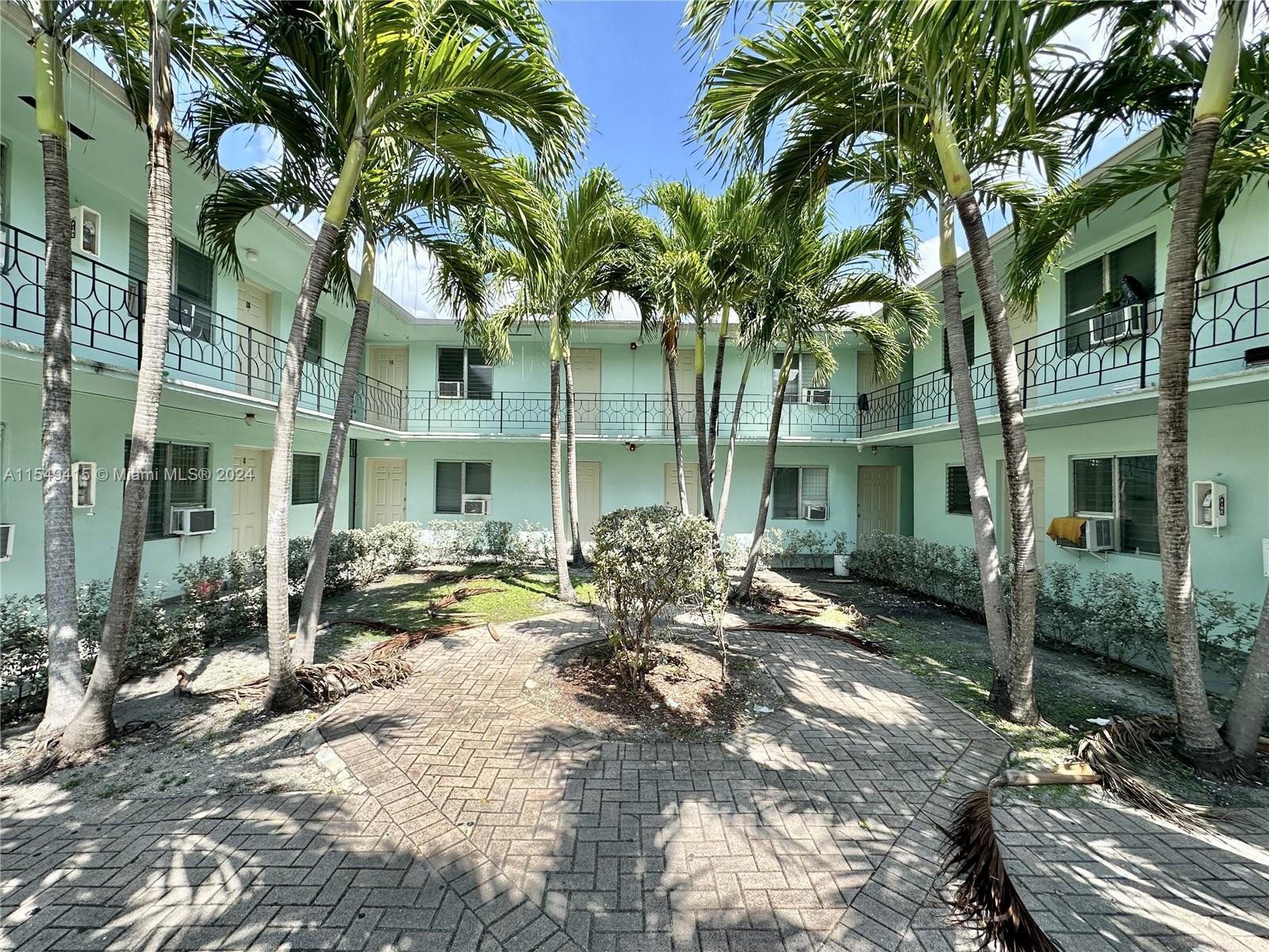 855 West 29th Street, Unit 14 Hialeah, FL 33012 - Photo 2 of 16 a view of a patio with table and chairs and potted plants