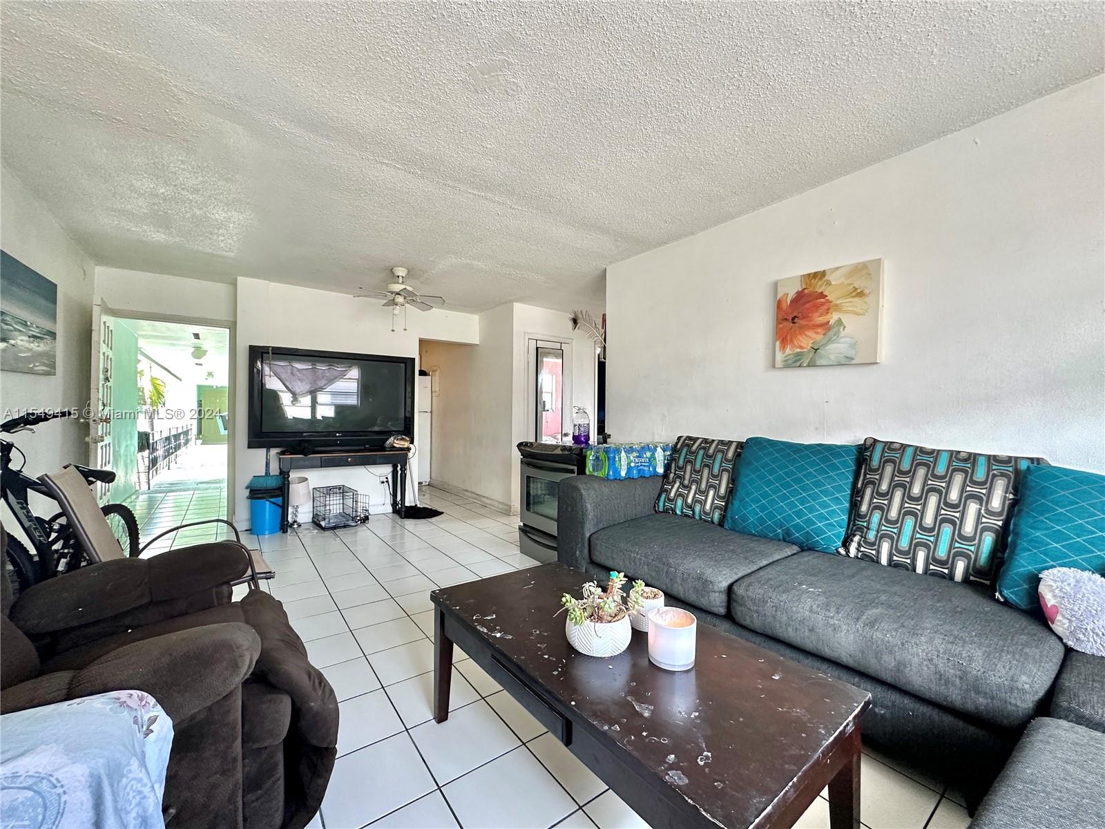 855 West 29th Street, Unit 14 Hialeah, FL 33012 - Photo 4 of 16 a living room with furniture and a flat screen tv