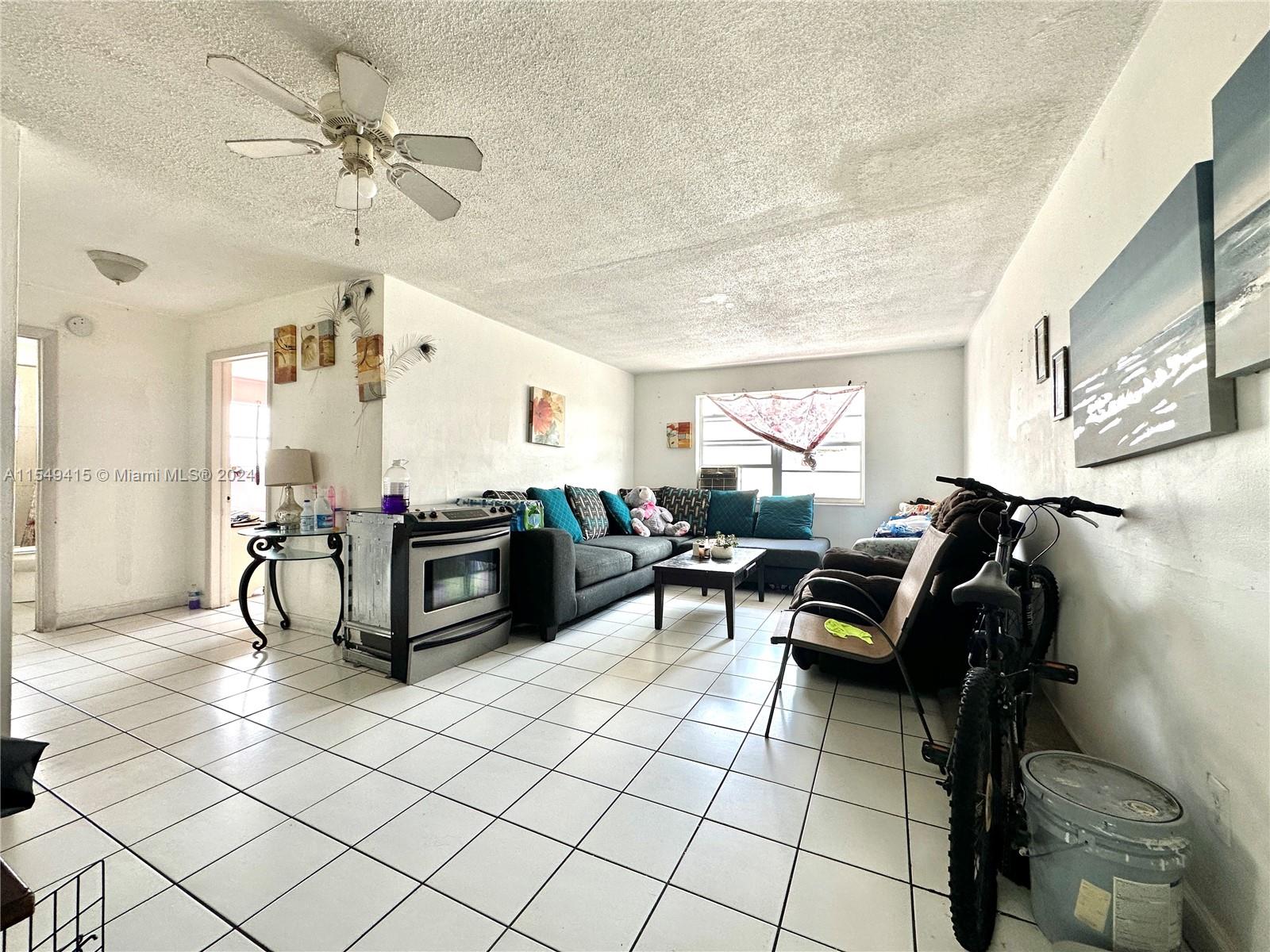 855 West 29th Street, Unit 14 Hialeah, FL 33012 - Photo 5 of 16 a living room with furniture and a chandelier