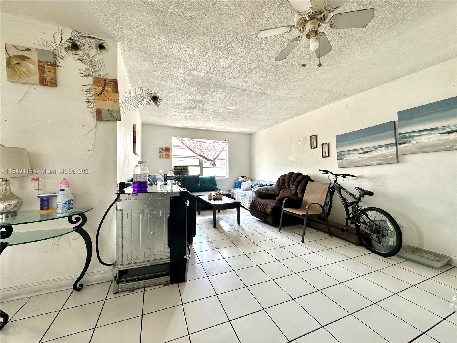 855 West 29th Street, Unit 14 Hialeah, FL 33012 - Photo 6 of 16 a living room with furniture a couch and a window