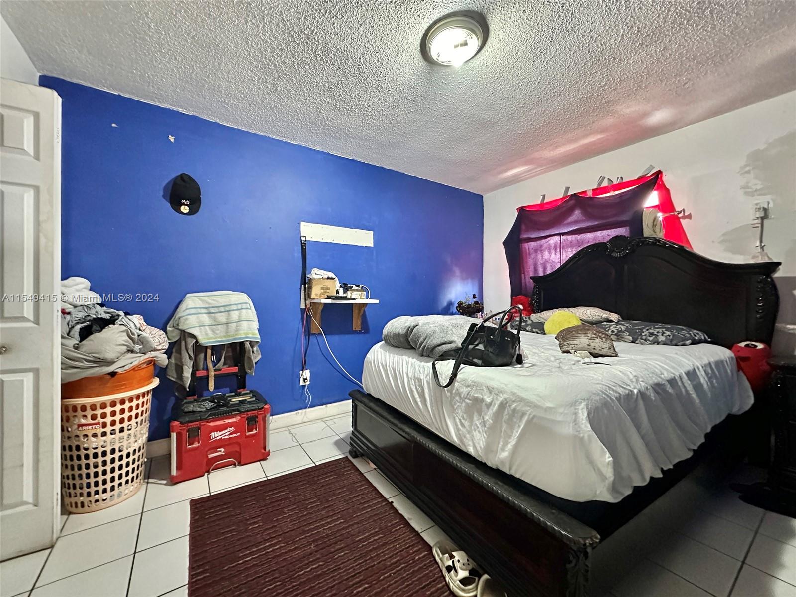 855 West 29th Street, Unit 14 Hialeah, FL 33012 - Photo 7 of 16 a bedroom with a bed and a lamp