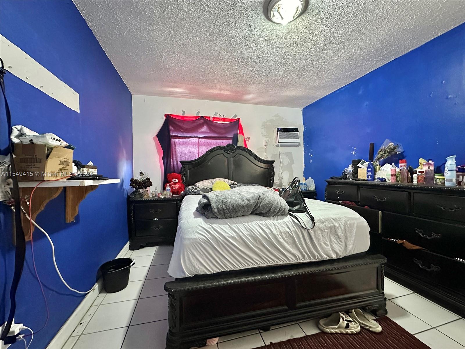 855 West 29th Street, Unit 14 Hialeah, FL 33012 - Photo 8 of 16 a bedroom with a bed and dresser