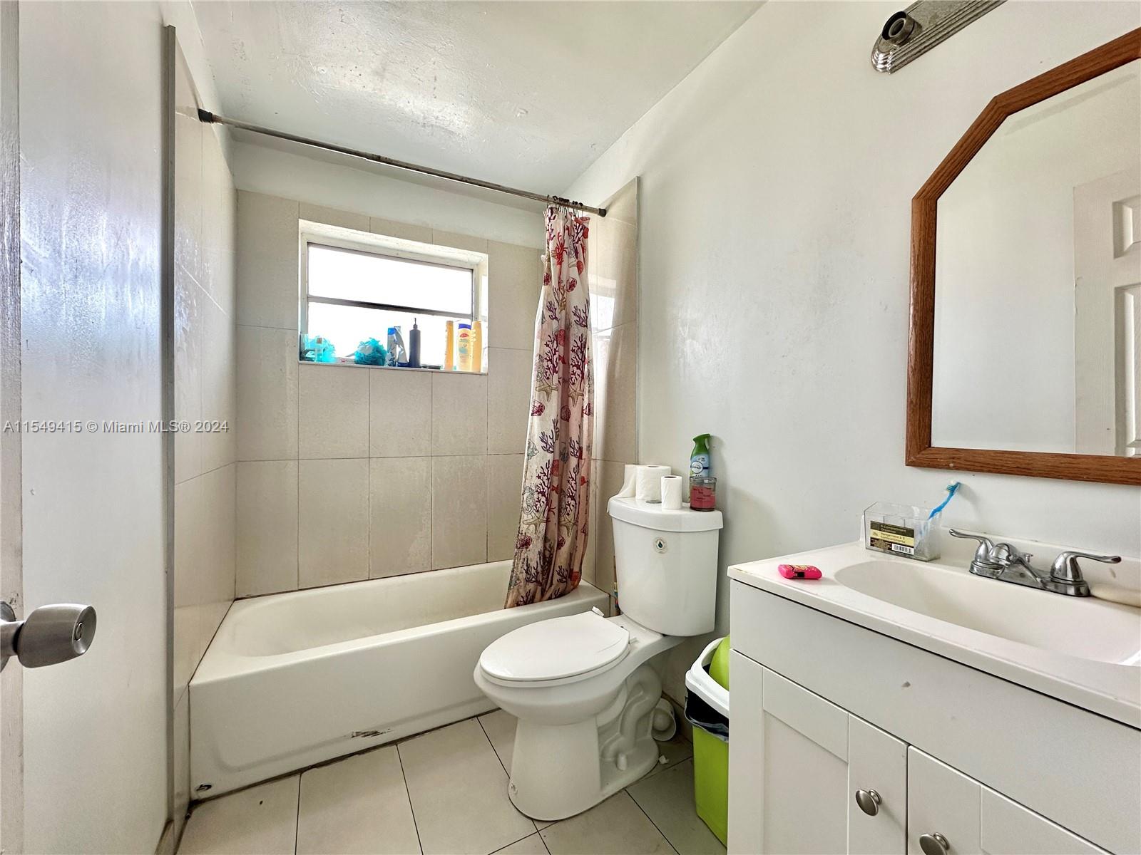 855 West 29th Street, Unit 14 Hialeah, FL 33012 - Photo 9 of 16 a bathroom with a sink a toilet and a mirror