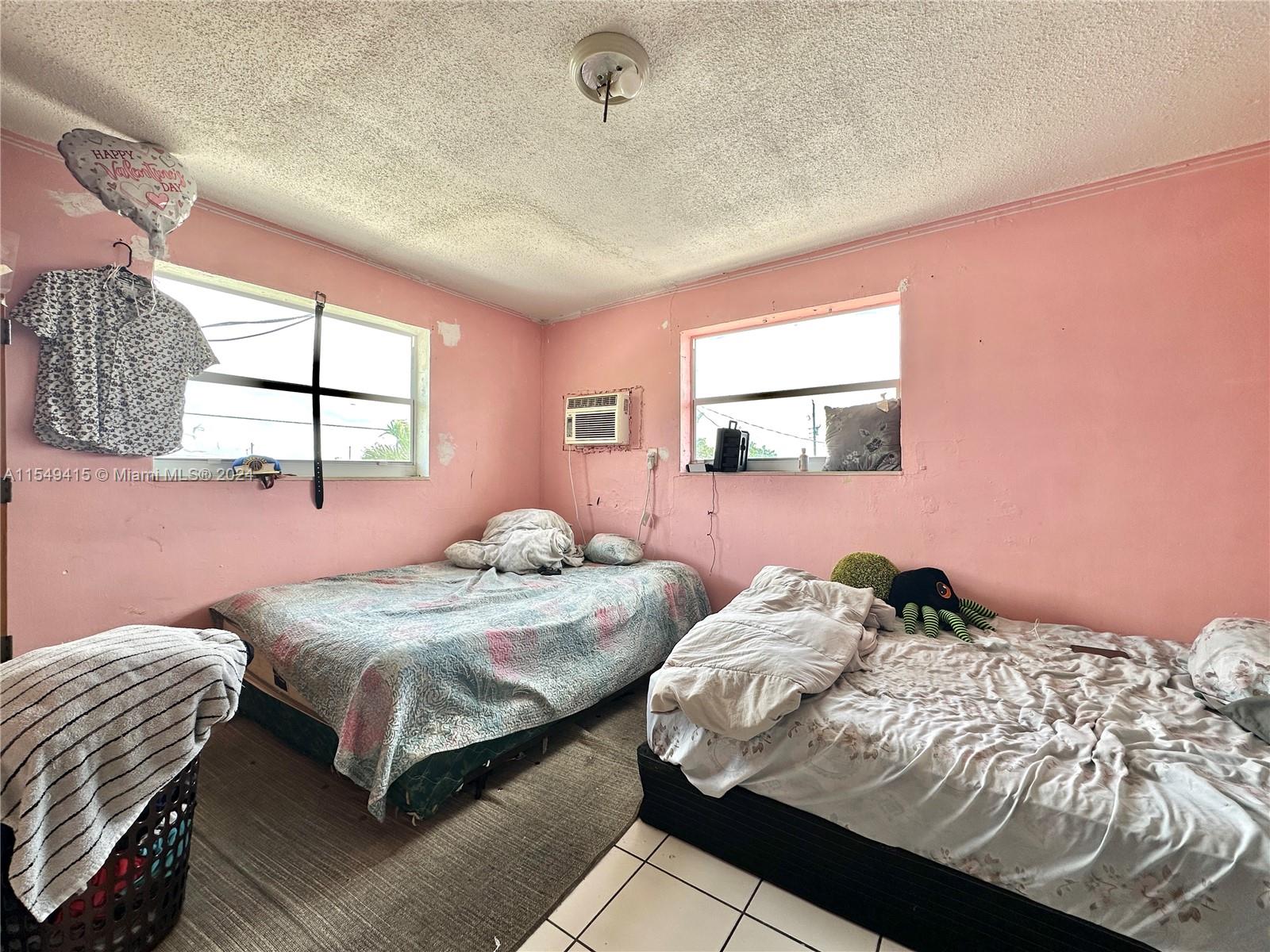 855 West 29th Street, Unit 14 Hialeah, FL 33012 - Photo 10 of 16 a bedroom with a bed and window
