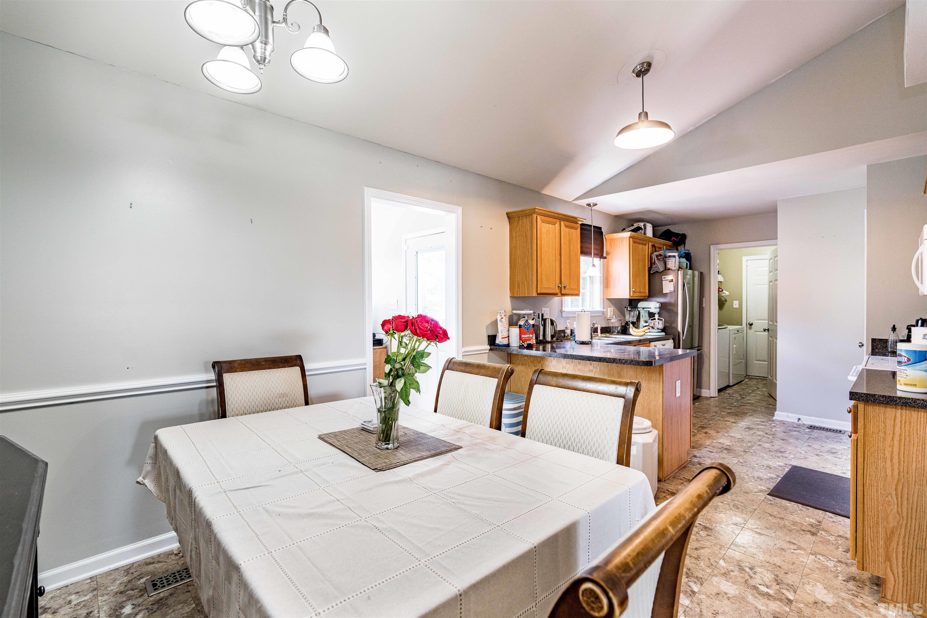 Dining area off kitchen has cathedral ceiling and chairrail molding!