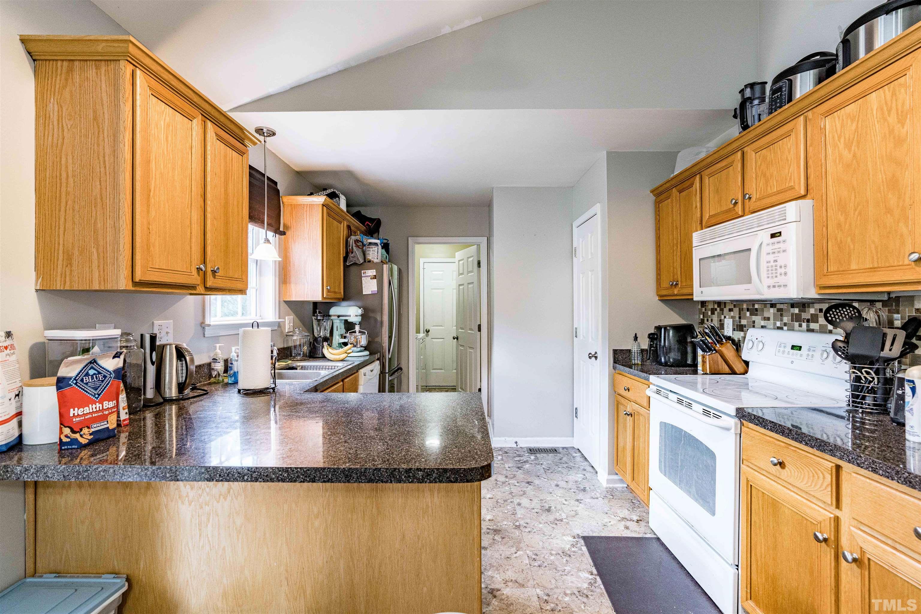 7200 Sunset View Court Willow Spring, NC 27592 - Photo 8 of 25 Kitchen w/lots of cabinets, pantry and breakfast bar!