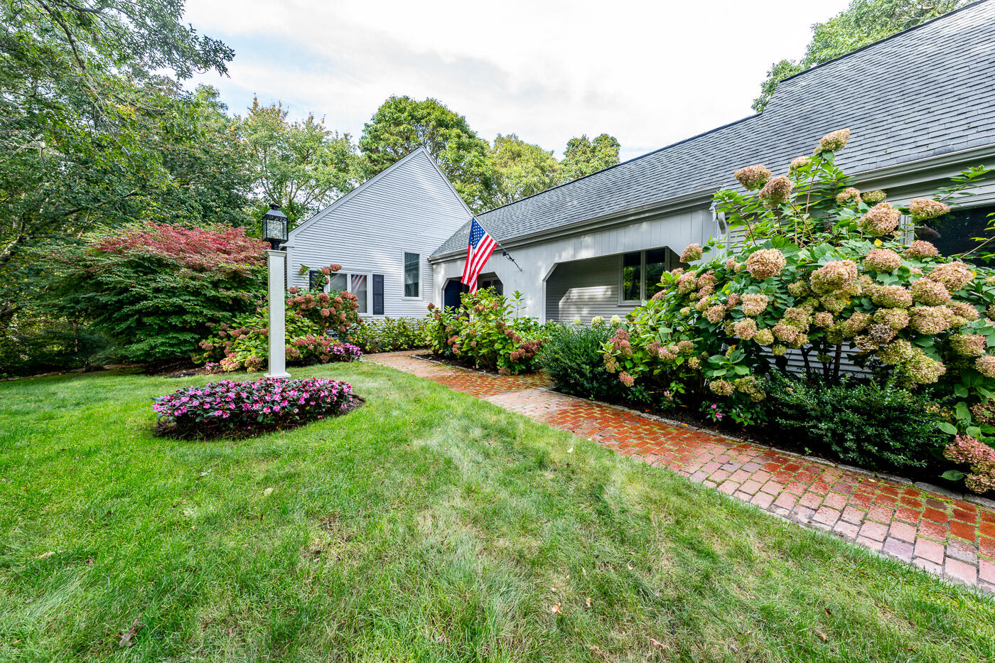 46 Sea Marsh Road Centerville, MA 02632 - Photo 1 of 69 a front view of a house with garden