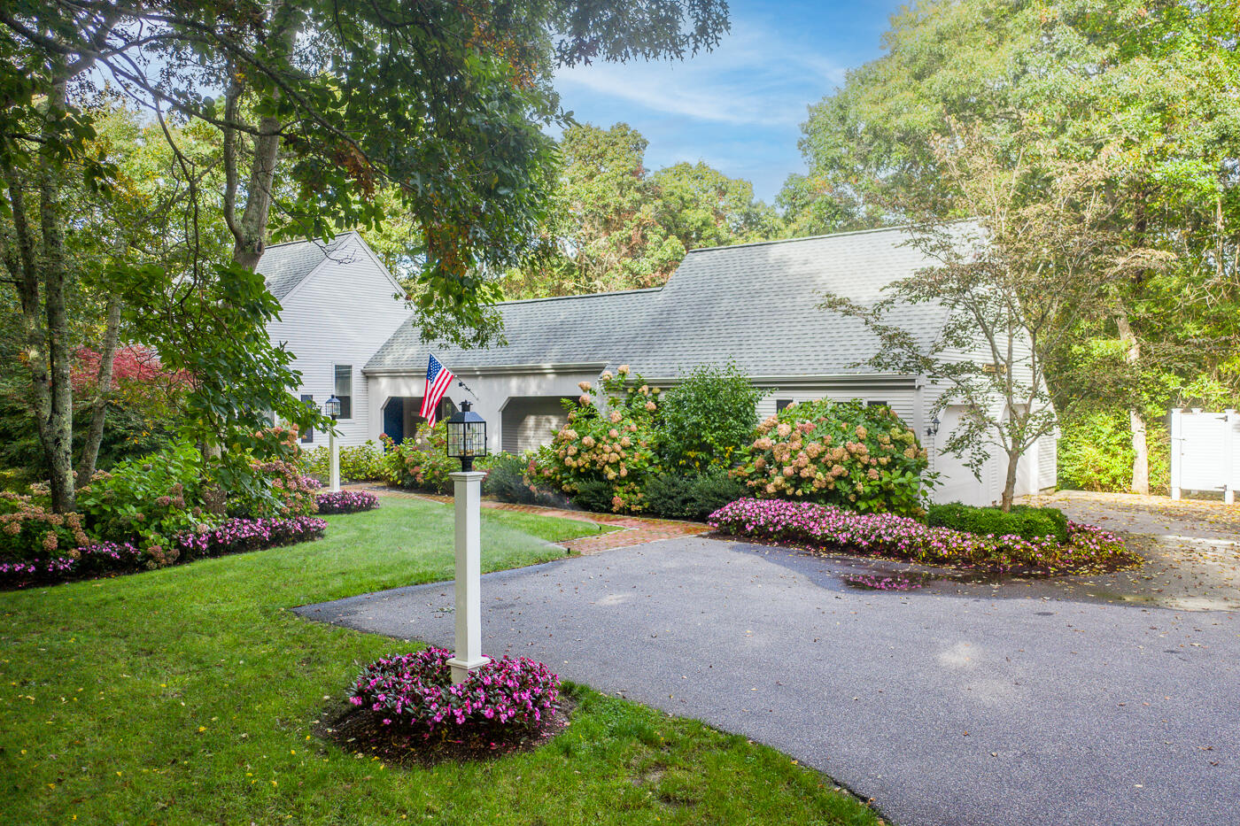 46 Sea Marsh Road Centerville, MA 02632 - Photo 2 of 69 a view of a garden with plants and a fountain