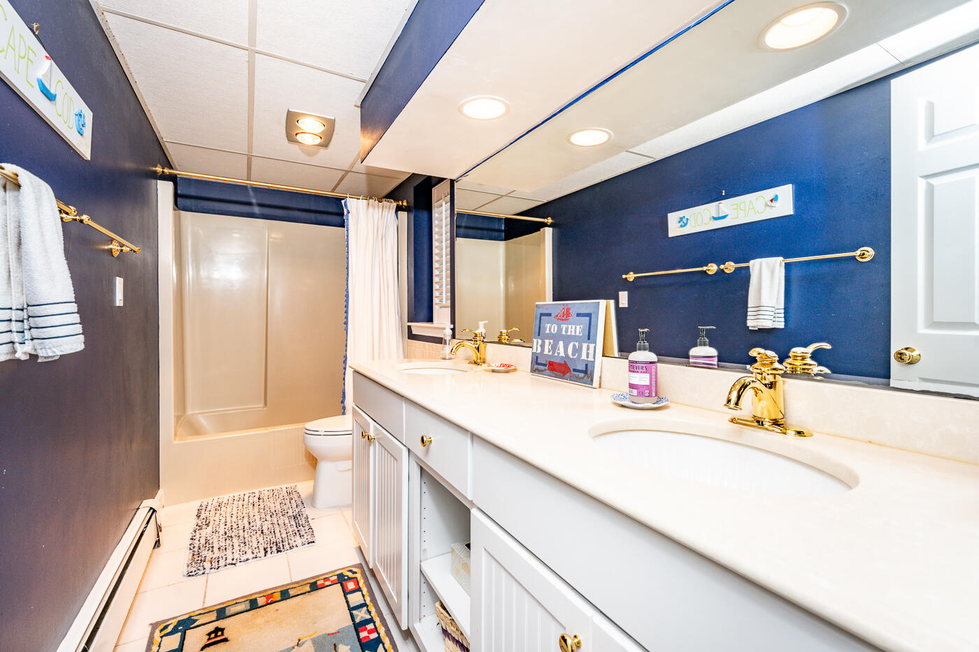 46 Sea Marsh Road Centerville, MA 02632 - Photo 49 of 69 a spacious bathroom with a double vanity sink a mirror and a shower