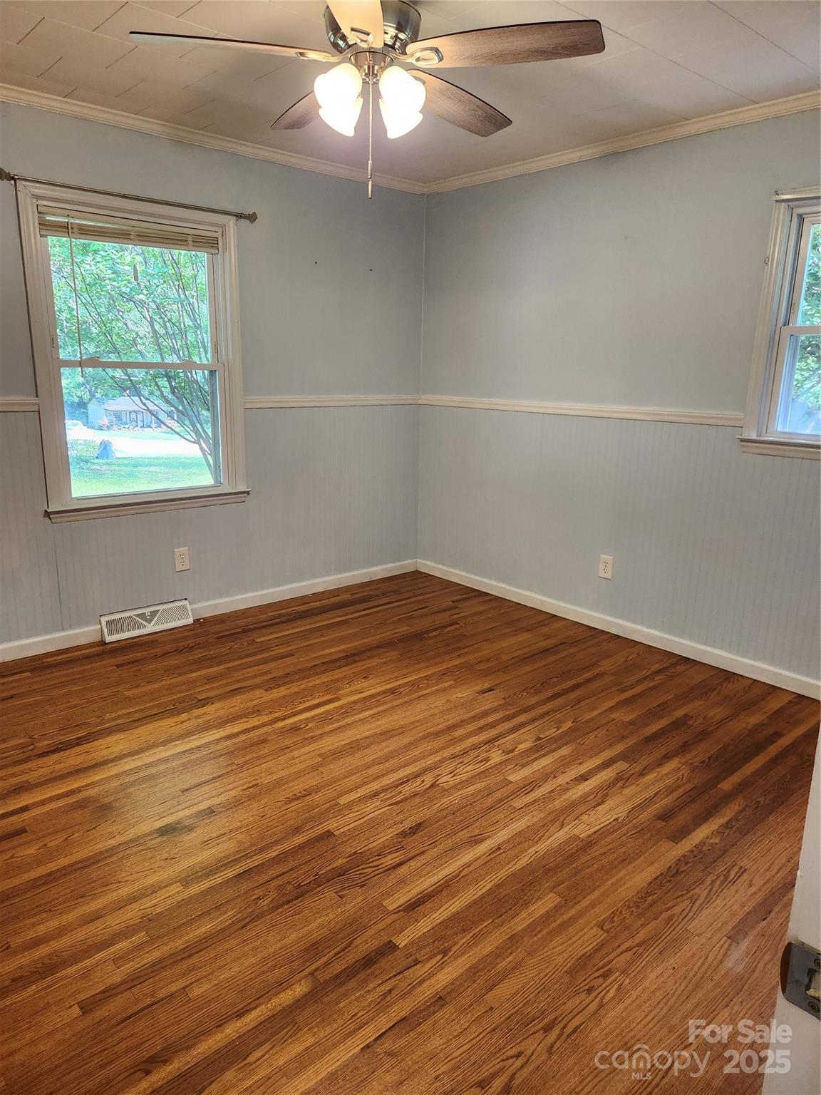490 South Moose Road Mount Pleasant, NC 28124 - Photo 13 of 16 an empty room with wooden floor fan and windows