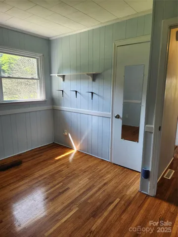 a room with wooden floor and window