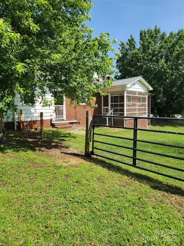 a view of a house with a yard porch and sitting area