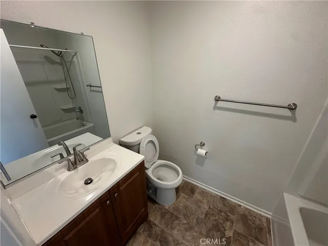 a bathroom with a sink toilet and a mirror
