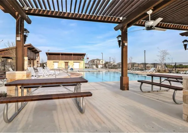 a view of a swimming pool with a yard