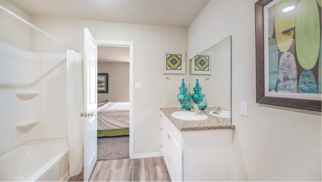 a bedroom with a bed and a painting on the wall