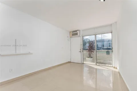 an empty room with sliding glass door