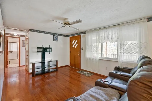 a living room with furniture and wooden floor