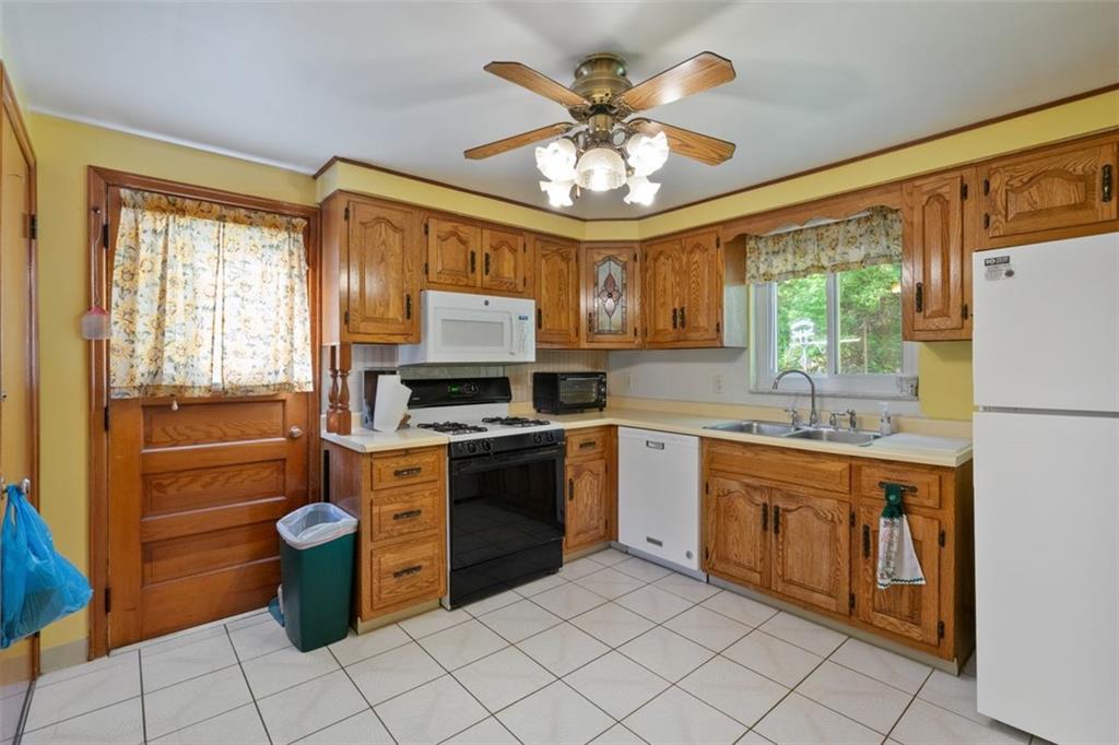 100 Longvue Drive Pittsburgh, PA 15237 - Photo 8 of 25 a kitchen with stainless steel appliances granite countertop a stove top oven a sink dishwasher and a refrigerator