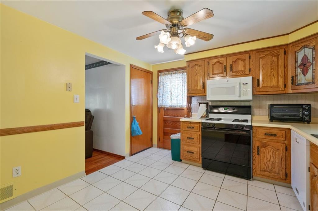 100 Longvue Drive Pittsburgh, PA 15237 - Photo 10 of 25 a kitchen with stainless steel appliances granite countertop a refrigerator a stove and a sink
