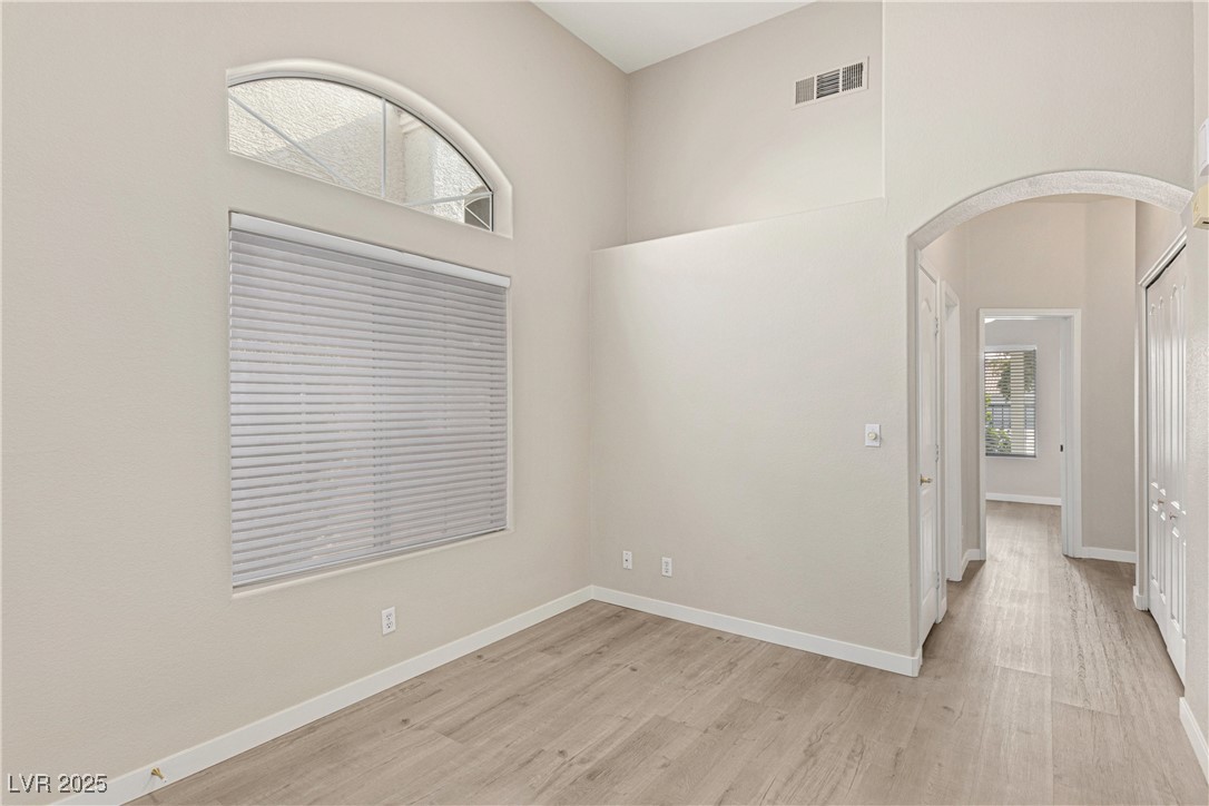 5240 Island Chain Road Las Vegas, NV 89118 - Photo 5 of 26 Unfurnished room featuring arched walkways and light wood finished floors