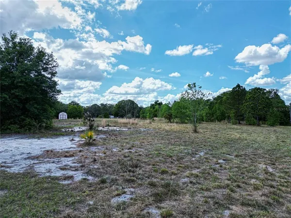 an aerial view of a houses with yard