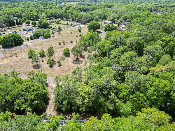an aerial view of a backyard of a house