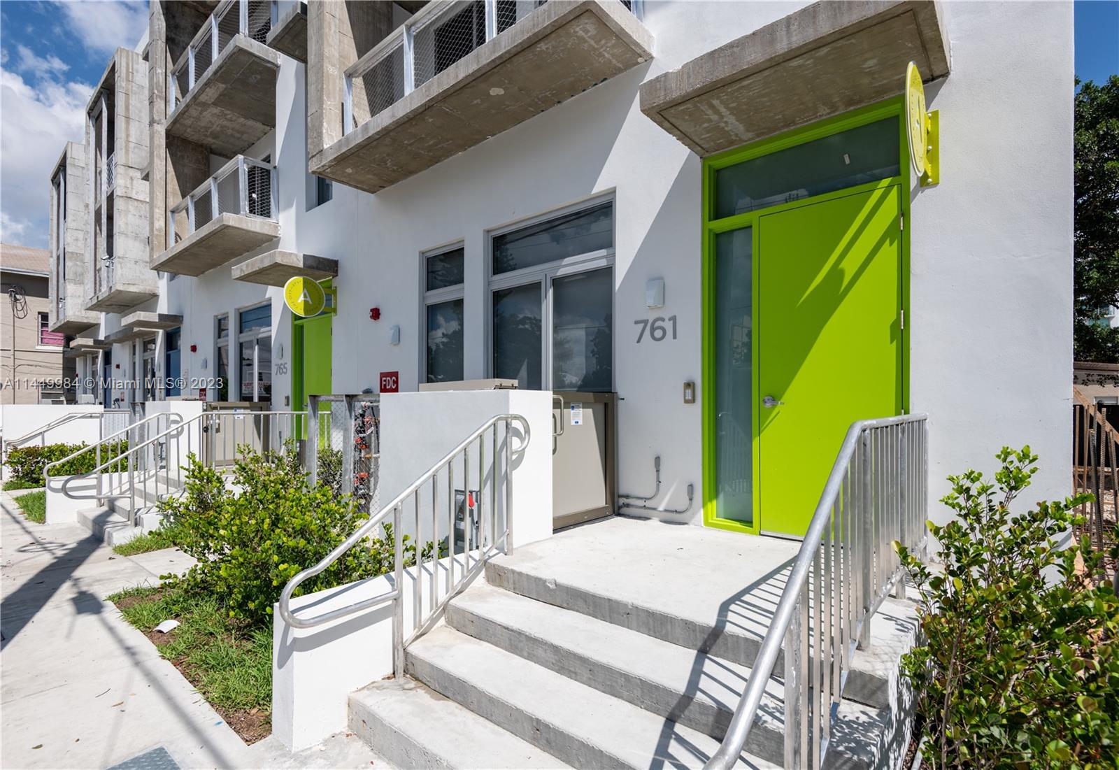 771 Northwest 1st Street, Unit 201 Miami, FL 33128 - Photo 12 of 34 a front view of a house with a garden
