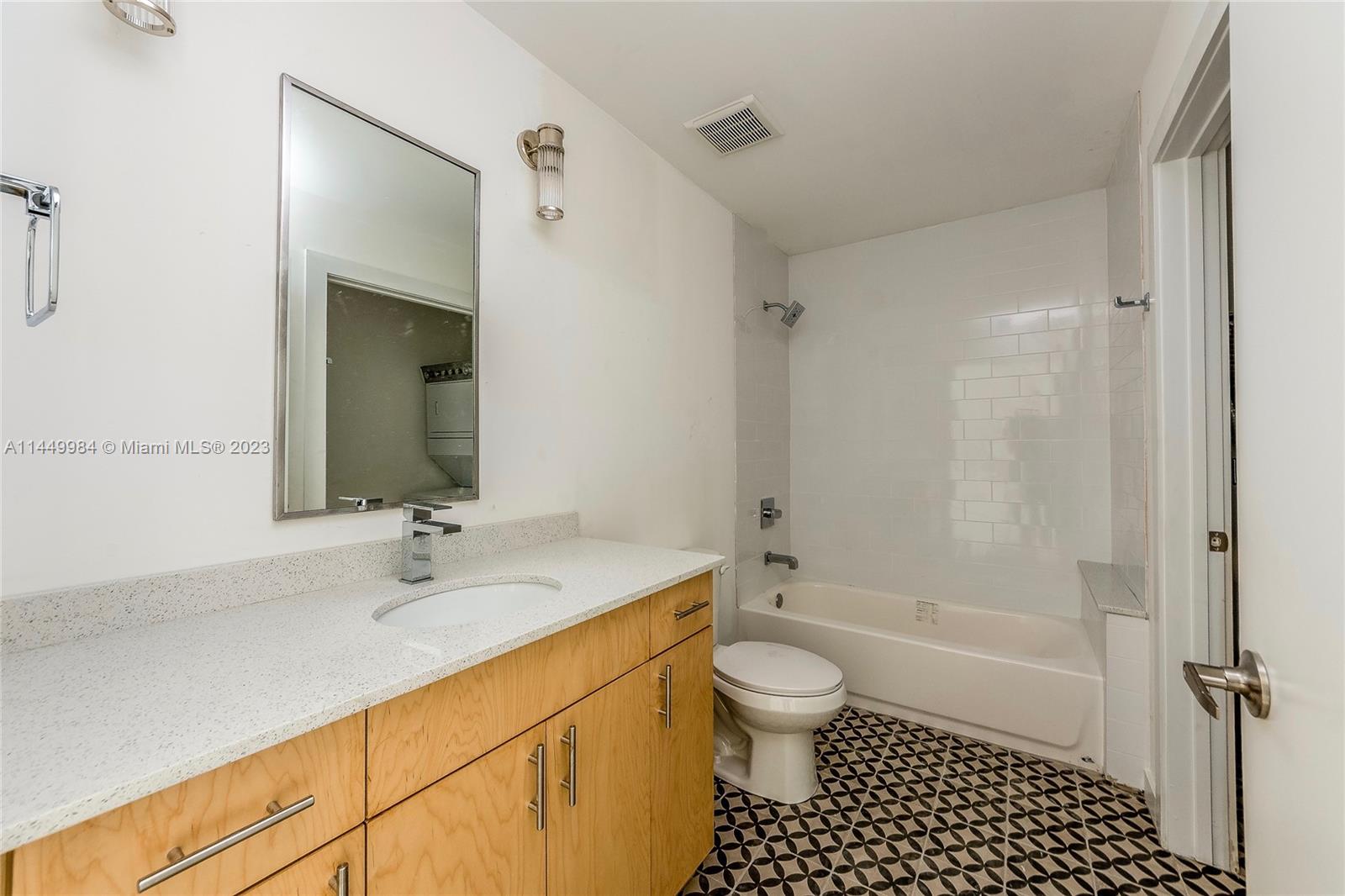 771 Northwest 1st Street, Unit 201 Miami, FL 33128 - Photo 20 of 34 a bathroom with a sink a toilet and shower