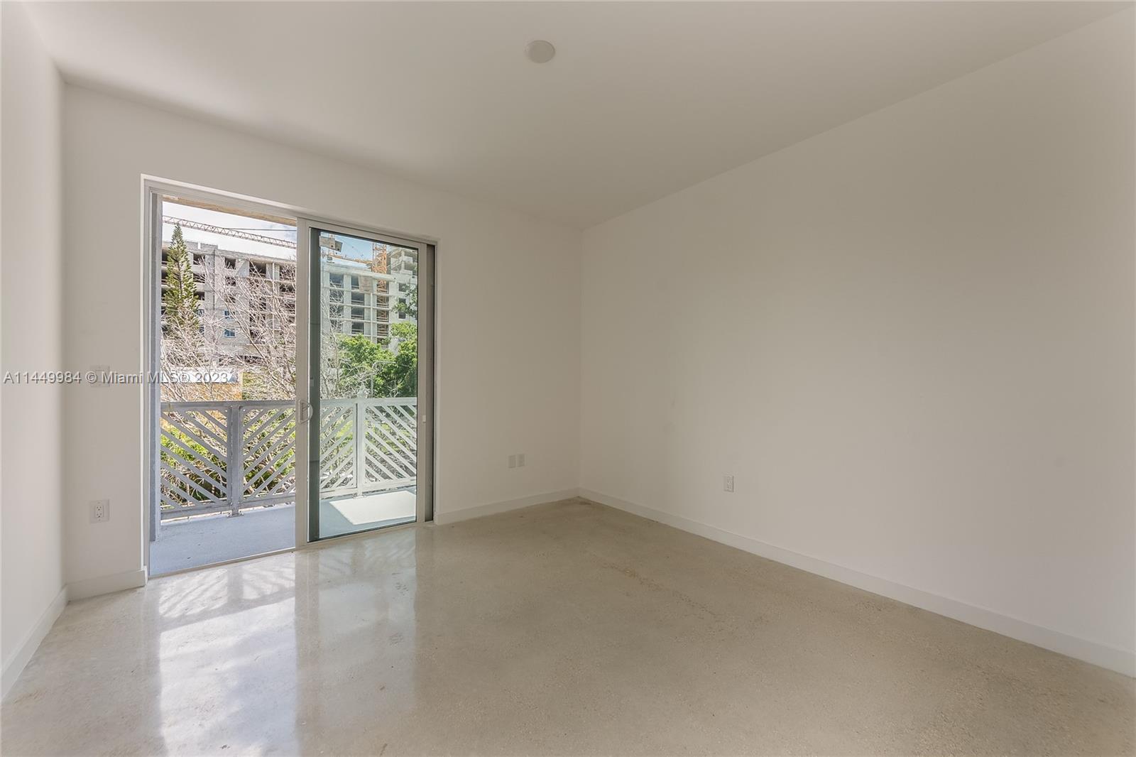 771 Northwest 1st Street, Unit 201 Miami, FL 33128 - Photo 22 of 34 an empty room with sliding door