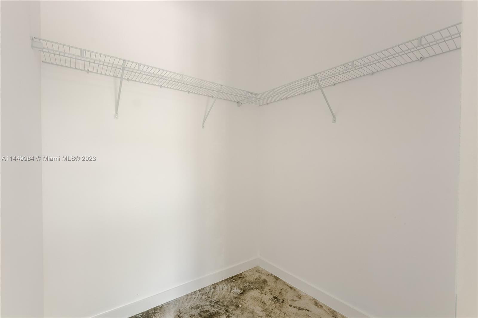 771 Northwest 1st Street, Unit 201 Miami, FL 33128 - Photo 25 of 34 a view of a room with racks on the wall