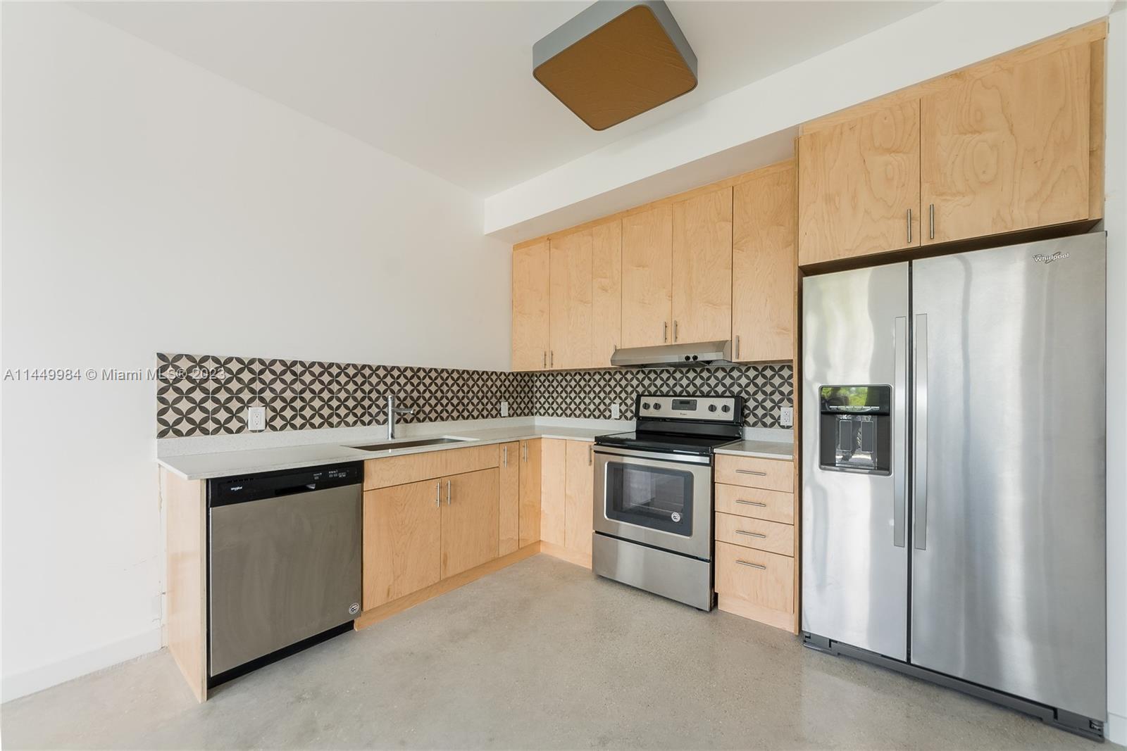 771 Northwest 1st Street, Unit 201 Miami, FL 33128 - Photo 27 of 34 a kitchen with stainless steel appliances a refrigerator sink and stove